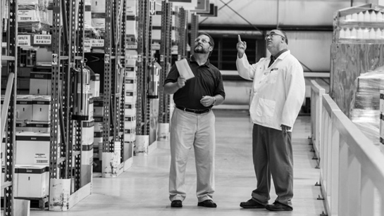 Two people talking in a warehouse