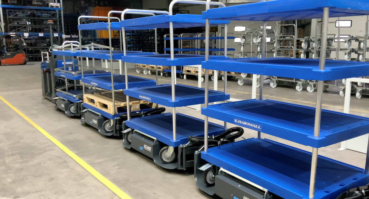 LiftLiner Tugger train with mother-daughter carts in blue.