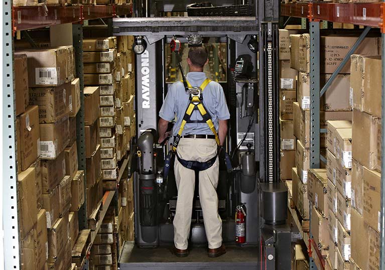 Raymond 9600 Swing Reach Truck in Aisle Driving Tractor First